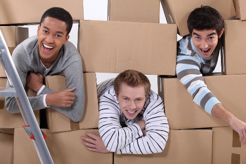 Local piano removals team transporting a piano through a Belgravia street