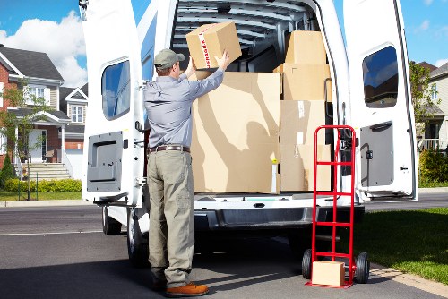 Removal team carrying furniture through a Belgravia property with narrow access