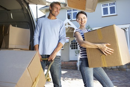 Staff using PPE while loading items into a van